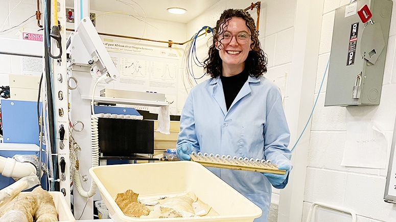 A geoscienes instructor shows off some rock samples in the lab