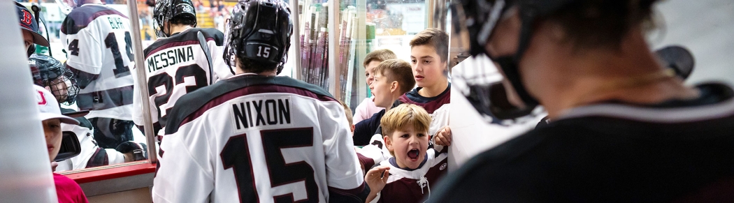 The Garnet Chargers take the ice as young fans cheer them on.