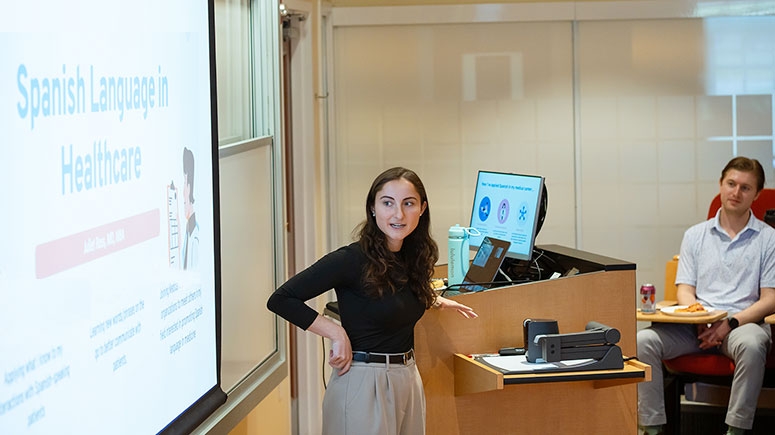A presenter looks at a screen during a career session focused on Spanish language careers.