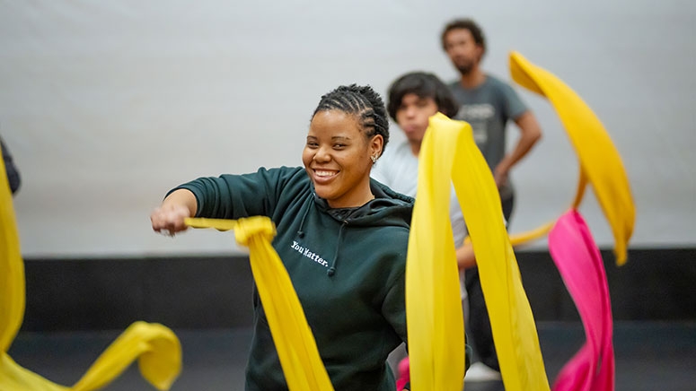 A student twirls ceremonial streamers used in various traditional Chinese celebrations.