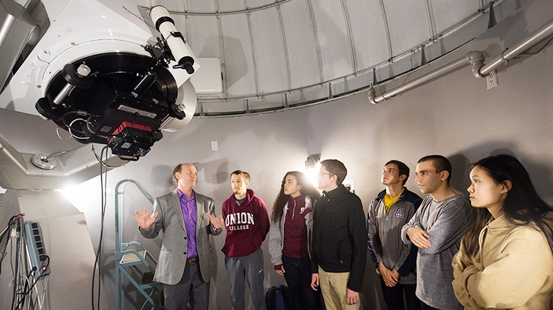 An astronomy professor explains the workings of a 20-inch Ritchey-Chretien telescope to Union students.